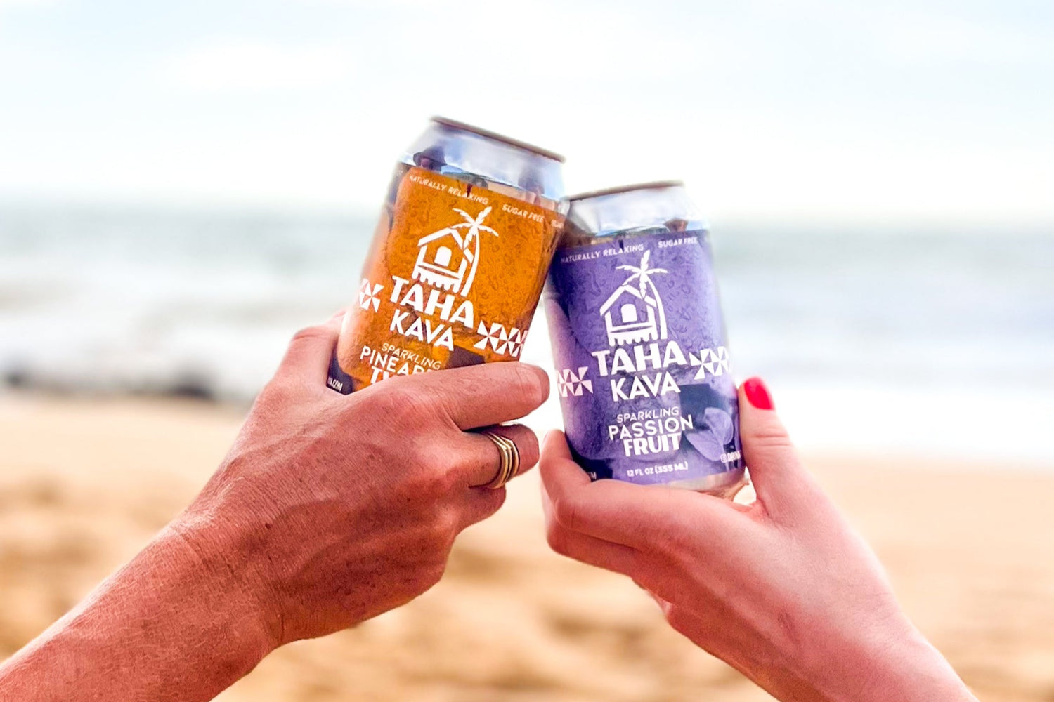 People cheering with Taha Pineapple and Lilikoi sparkling kava on the beach